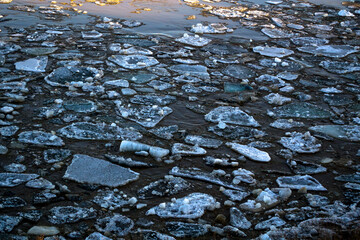 Thick ice pieces on the river in the winter thaw.