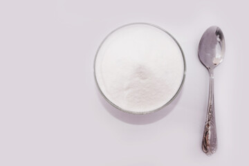 baking soda and spoon on a white background. View from above. Copy space.