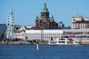 Skyline of downtown Helsinki with Uspenski orthodox church in the background. The ferry to Suomenlinna in the foreground.