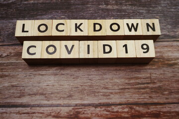 Lockdown Covid19 alphabet letters on wooden background