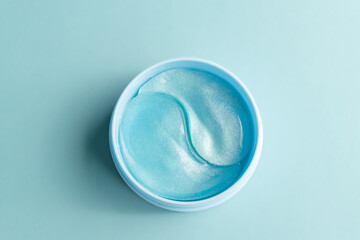 cosmetic hydrogel patches for moisturizing and nourishing the skin under the eyes on bue background.Skin care, wellness and spa concept, mockup with copy space.