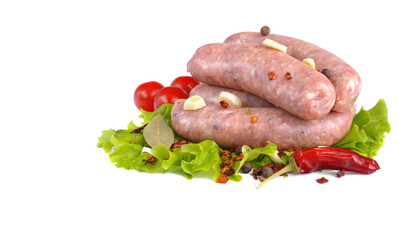 Raw grilled pork sausages close-up on a lettuce leaf with cooking spices, isolated on a white background.Selective focus.