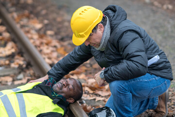 African American railroad engineer injured in an accident at work on the railway tracks. Coworker...