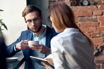 young couple work colleagues professional communication in a cafe