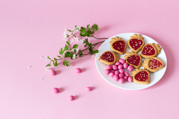 pink candy and cookies on a pink background