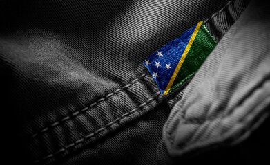 Tag on dark clothing in the form of the flag of the Solomon Islands