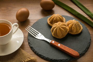 Kueh Bolu or Kuih Bahulu is the Asian traditional food popular in Malaysia and Indonesia.It is a sponge cake baked in special aluminum molds. Serve with a cup of tea.