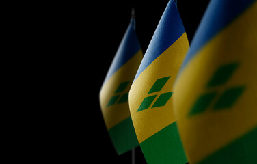 Small national flags of the Saint Vincent on a black background