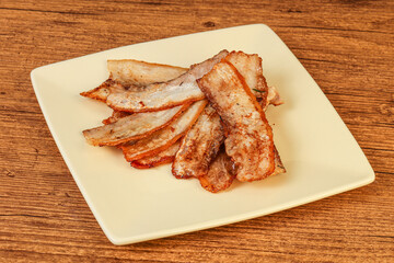Roasted juicy bacon in the plate