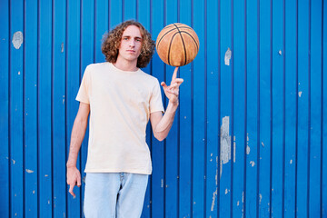 young man with curly hair with his basketball ball in his hand