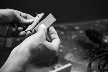 A Mechanic Does Carpenter Jobs With Wood, Saw, Hammer, Nail, Plus And Other Tools