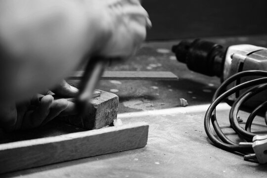 A Mechanic Does Carpenter Jobs With Wood, Saw, Hammer, Nail, Plus And Other Tools