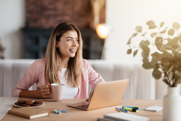 Ambitious young lady beginning her day with smile and coffee