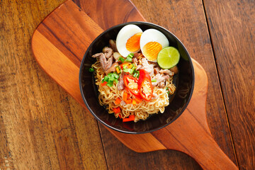 Boiled instant noodles, soup with minced pork and cooked egg.