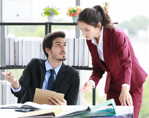 Businessman and businesswoman arguing in office