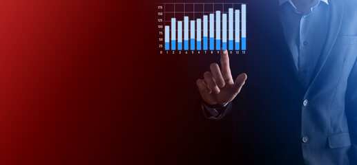 Businessman hold drawing on screen growing graph, arrow of positive growth icon.pointing at creative business chart with upward arrows.Financial, business growth concept.