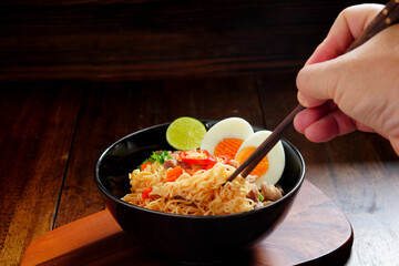 Boiled instant noodles, soup with minced pork and cooked egg.