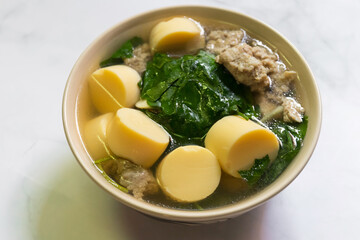Clear soup with egg tofu, minced pork and Ivy Gourd vegetables. 