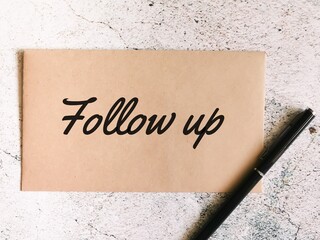 Text follow up written on brown envelope.Business concept.