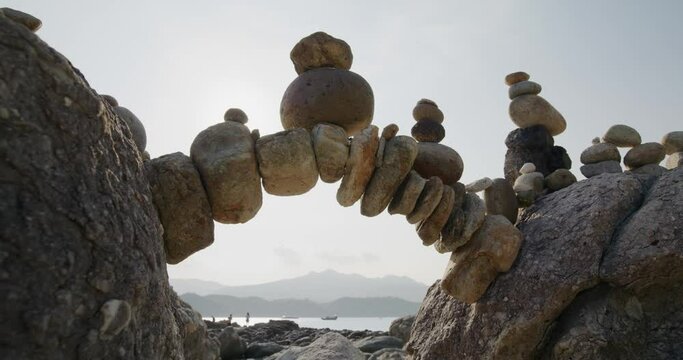 Arch of pebbles in balancing on the sea coast