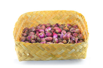 red onion in woven bamboo isolates on white background