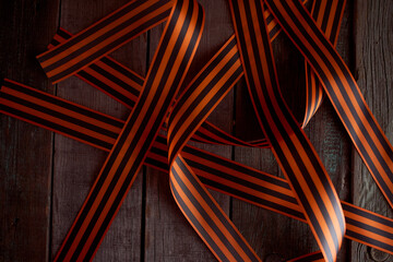 Black orange St. George ribbons on a wooden background