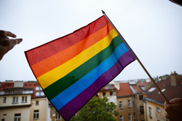 Flag symbol of the lgbt community on the background of the rooftops of an old european city