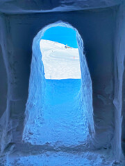 Tunnel dug through deposits of fresh snow above the Glacier du Sex Rouge in the alpine mountain...