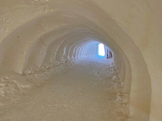 Tunnel dug through deposits of fresh snow above the Glacier du Sex Rouge in the alpine mountain...