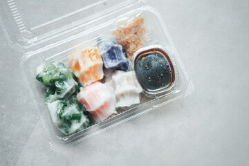Mix of various steamed dumpling stuffed such as garlic chives, taro and bamboo shoot with sweet sauce in box