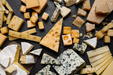 Cheese plate on black table, top view