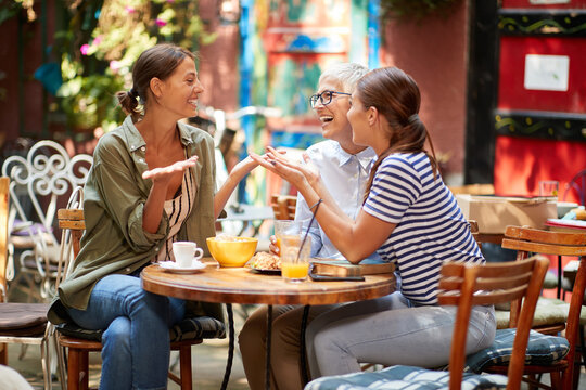 A group of female friends of different generations having fun while they have a drink in the bar after long time. Leisure, bar, friendship, outdoor