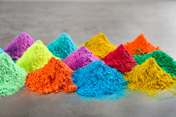 Colorful powder dyes on grey background. Holi festival
