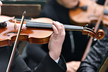 violin during a concert , with hands and a bows 
