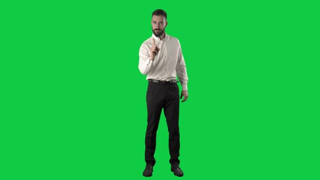 Angry strict business man or teacher scolding finger and shaking head. Full length on green screen chroma key background.