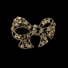gold jewelry in the form of a bow with white crystals. vintage brooch in the form of a bow