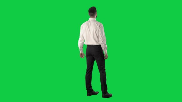 Fascinated and impressed business man looking up around and turning around shopping sales. Full length on green screen chroma key background.