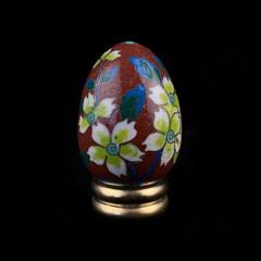 set of wooden Easter eggs with floral patterns on isolated black background