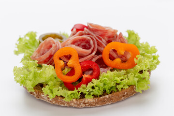 Sandwich with salami sausage on white background.