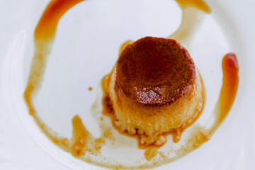 delicious flan with egg and caramel on the white plate