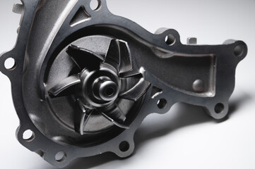 Water pump of the internal combustion engine cooling system. Contrasting on a gray gradient