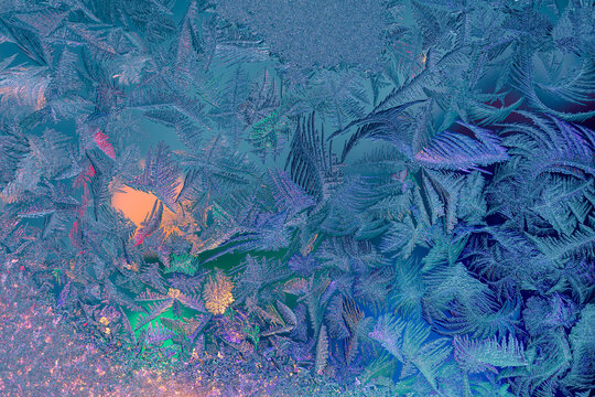 Natural ice texture on the frozen window in colorful light. Gradient color. Christmas background