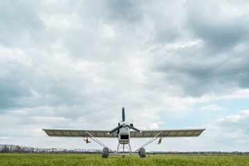 remote controlled agriculture spaying air plane in field at sunset, no people