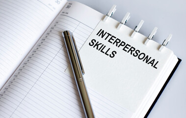 text Interpersonal skills on the short note texture background with pen. Business concept