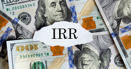 USA dollar with finance text Internal Rate of Return IRR on torn piece paper. Business concept