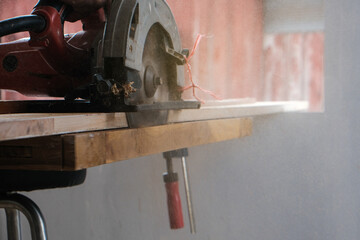 Wood working of teak wood door inside modern new house.