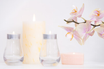 Fototapeta na wymiar Burned candles and orchid flowers. Calm and relax concept.
