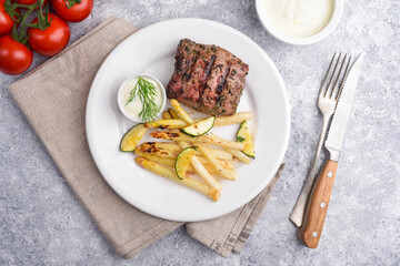 Venison BBQ Steak with the grilled asparagus, courgettes, fennel, tomatoes and garlic dill sauce