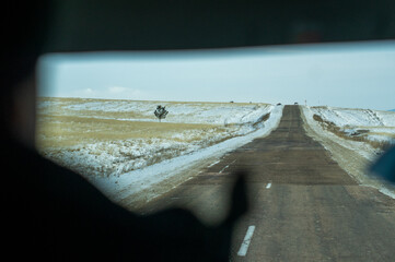through the steppe on a road view from a car window