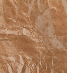 Crumpled beige paper texture close up isolated on white background.